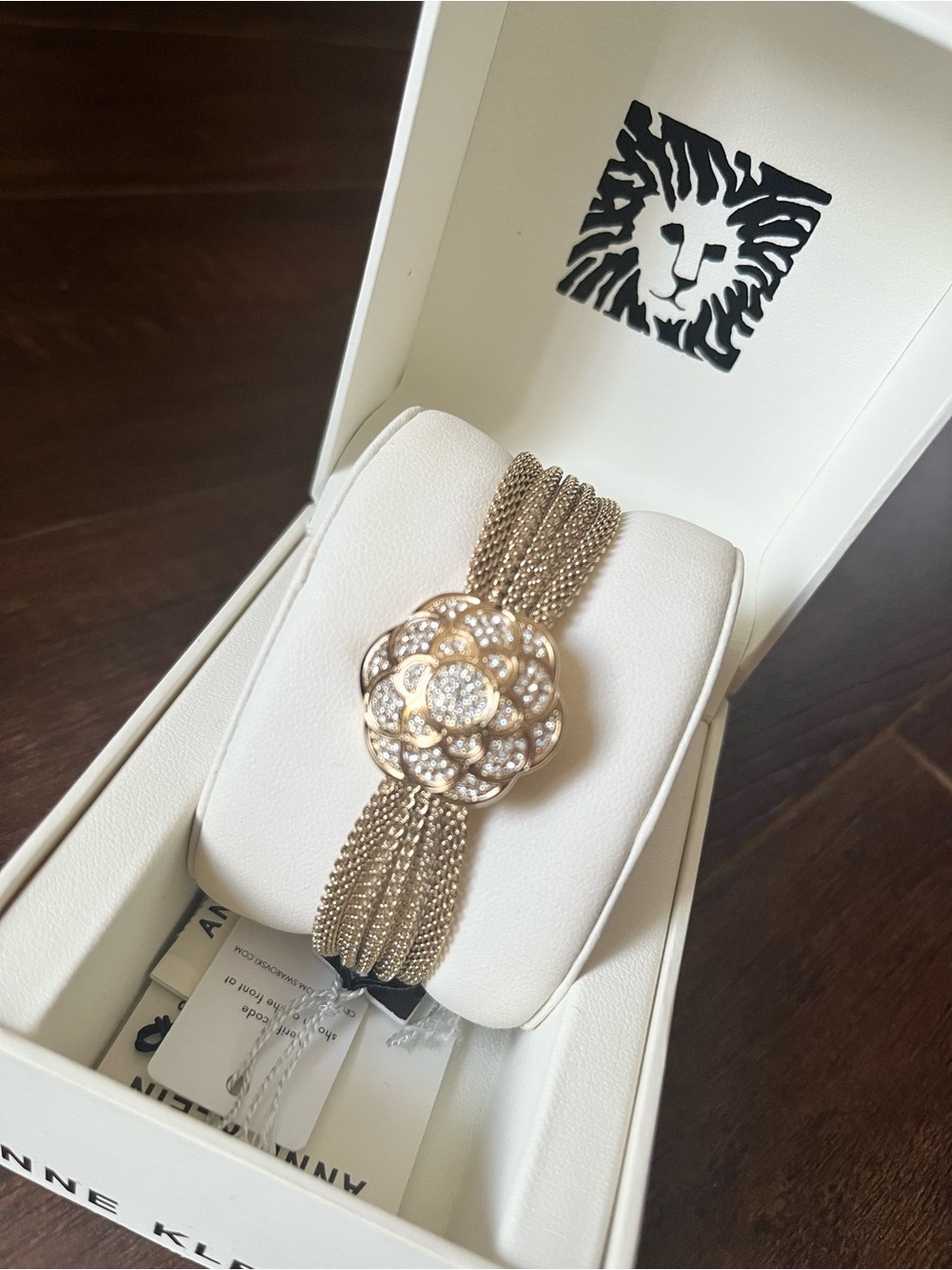 Anne Klein Gold-Tone Bracelet watch with Floral Crystal Design.